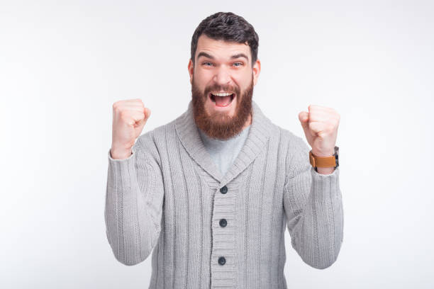 istock I won! Young man is making winner gesture on white background. 1201282805