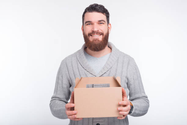 istock Time for lunch and delivery.  Bearded man is holding a lunch box. 1201282985