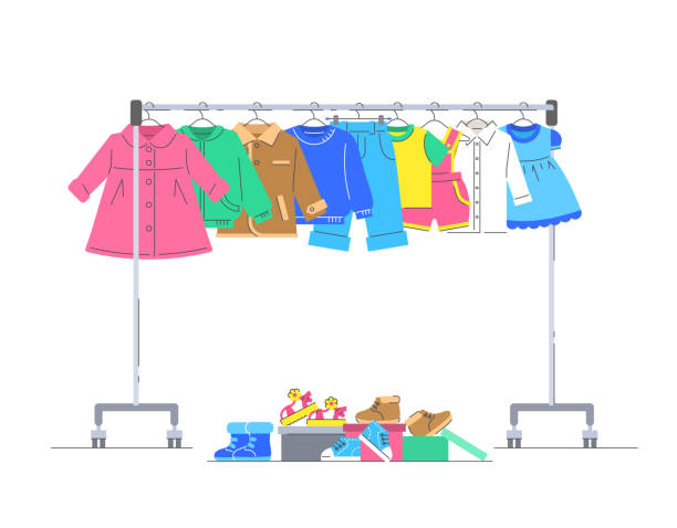 Baby clothes on hanger rack with shoes Baby clothes on hanger rack with shoes. Flat lines vector illustration. Casual little kids apparel hanging on shop rolling display stand. Children store sale concept. Charity donation garment store fashion rack stock illustrations
