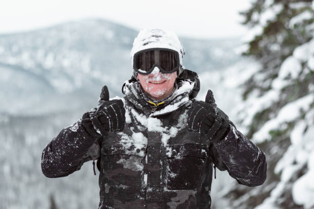 Snowboarder. Snowboarder with snowboard os showing a thumbs up in the winter forest in the mountains. thumbs up for skiing stock pictures, royalty-free photos & images
