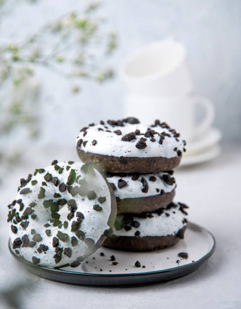 istock several delicious fresh hearty black and white doughnuts are stacked in a white plate on a white background 1201285923