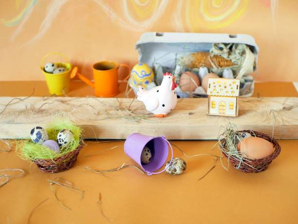 istock Easter decor, eggs, toy chicken on a light wooden table 1201286897