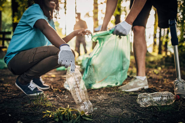 istock Volunteers with garbage bags cleaning park area 1201287375