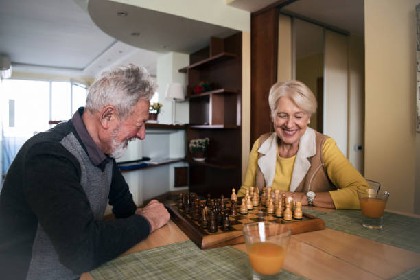 istock Senior Couple is Playing Chess Game at Home 1201287712