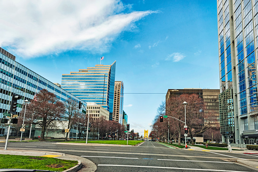 Sacramento, California, USA - February 16, 2019: This View of Capital Mall in Sacramento California is a straight road to the Tower Bridge which is located next to Old Town and the Sacramento River, both sides of this mall road way offers a variety of architectural features with high rise structures and various other banks and offices this view thru glass is very picturesque and on this February day it was well worth the view.