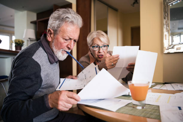 istock Senior couple checking their bills at home 1201288852