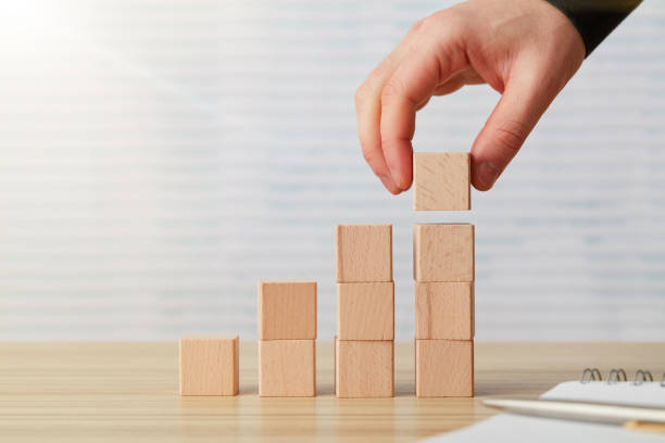 istock Hand arranging final  wooden block 1201290283