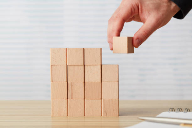 istock Hand arranging a wooden block 1201290364