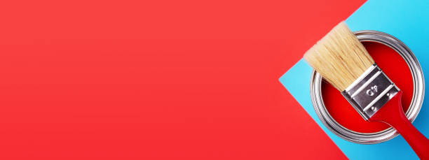 istock Can of red paint on red and blue background. 1201290416