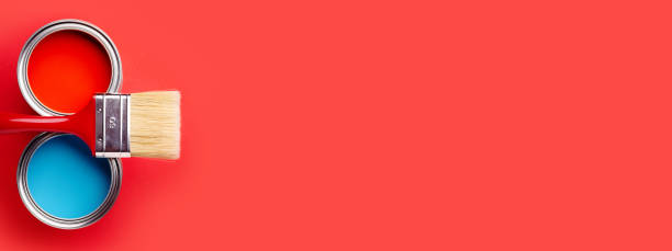 Two cans of blue and red paint on red.