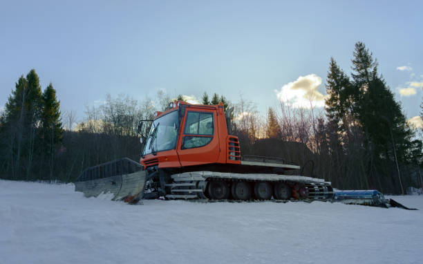 istock Snow groomer machine on ski track ready to work at sunrise 1201290892
