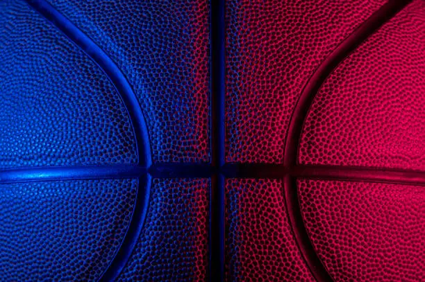 Closeup detail of basketball ball texture background. Blue neon Banner Art concept