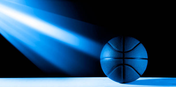 istock Basketball ball isolated on black background. Blue neon Banner Art concept 1201292995
