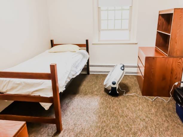 Basic Nondescript Single Occupancy Student Dormitory Room Basic white box dormitory room. dorm room photos stock pictures, royalty-free photos & images