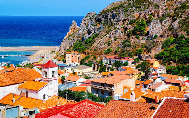 Cityscape of Buggerru city in Mediterranean Sea in South Sardinia reflex Cityscape with Buggerru city with cottage house architecture at the Mediterranean Sea in South Sardinia in Italy. Sardinian Italian small town in Sardegna. Buggerru stock pictures, royalty-free photos & images