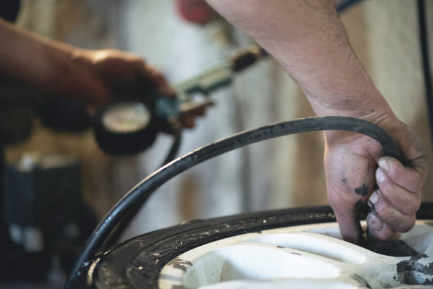 istock Car tire repair. 1201294038