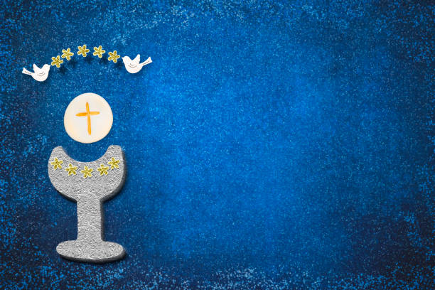 istock First holy communion invitation card.Golden chalice, flowers and doves 1201294199