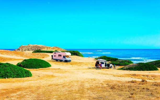 istock Car and Camper at Capo Pecora Mediterranean Sardinia reflex 1201295433