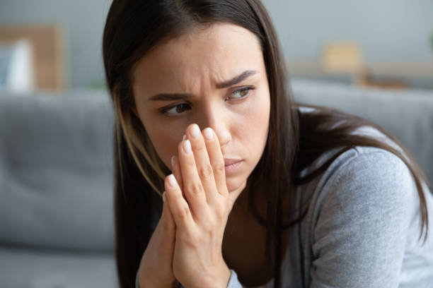 istock Close up unhappy young woman thinking about problems alone 1201295606