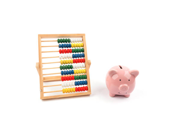 istock Abacus and piggy bank on white 1201296429