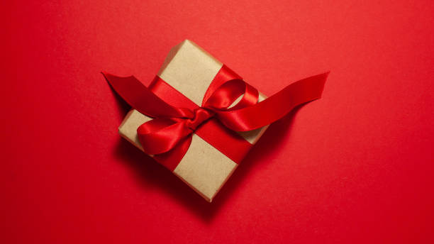 istock Gift box brown paper with satin ribbon bow directly above 1201297595