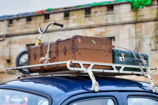 istock Old luggages atop of an old car 1201300197