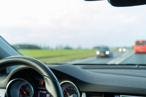 istock Car dashboard while driving on the highway in the dutch landscape 1201300363