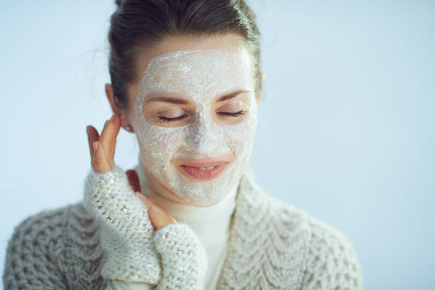 istock relaxed modern woman with white facial mask 1201300964