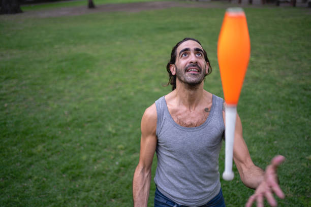 istock Cheerful Hispanic juggler juggling at a park 1201302081