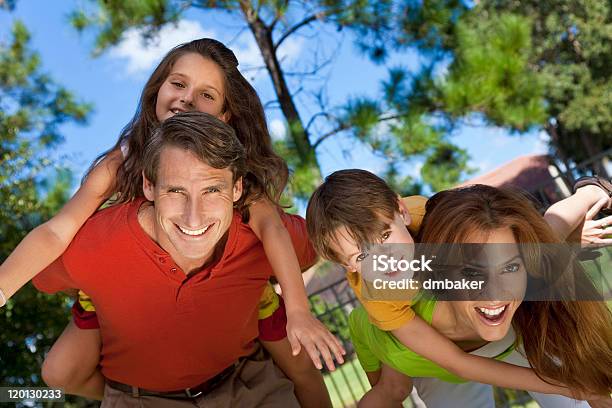 Happy Family Having Fun Outside In Park Stock Photo - Download Image Now - 30-39 Years, Adult, Beautiful People