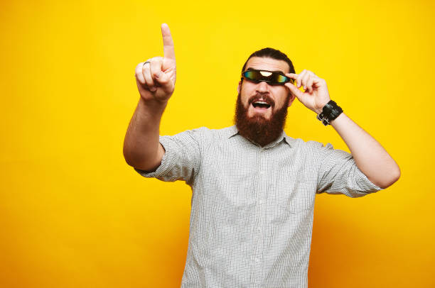 istock Amazed bearded man with cyclop glasses showing up 1201304892