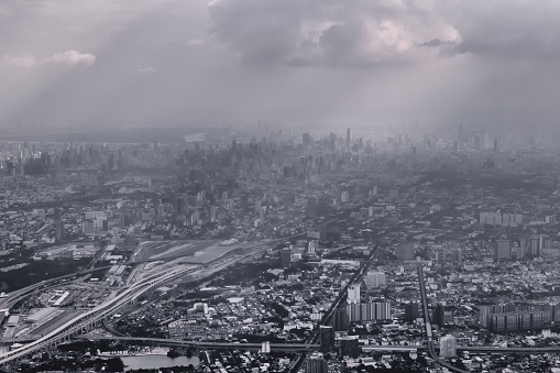 Aerial view of Bangkok, Thailand, polluted air over the horizon. Urban sprawl, metropolis. Black and white color toned vintage effect.