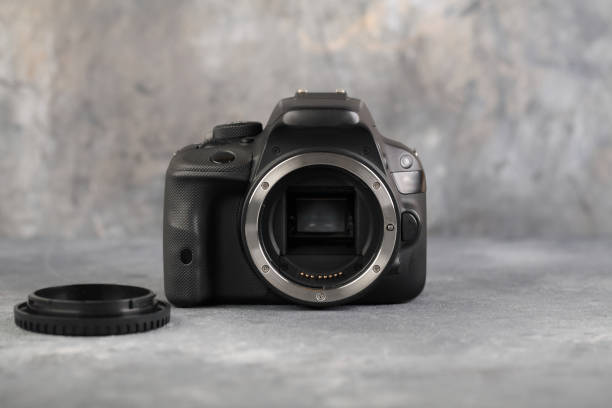 istock DSLR Digital Camera APS-C sensor of A EOS Canon 100D on gray cement background. 1201309092
