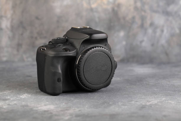 istock DSLR Digital Camera APS-C sensor of A EOS Canon 100D on gray cement background. 1201309095