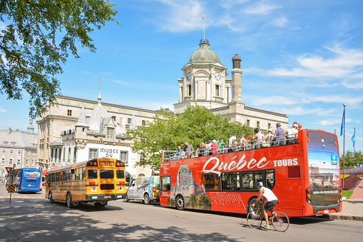 QUEBEC, CANADA - AUGUST 20, 2014: Sightseeing red tourist bus rides at Quebec in Canada
