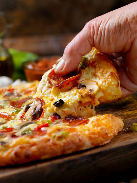 istock Taking the First Piece of Pizza 1201310899