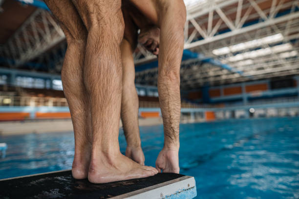 istock Senior man preparing for a jump from a swimming starting block 1201311691