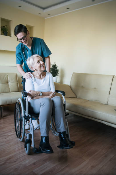 istock Young Caregiver is Helping a Disabled Person 1201312423