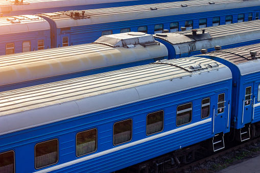 Old blue trains on railway station platform.