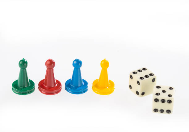 istock game pieces with dice isolated on white background 1201315736