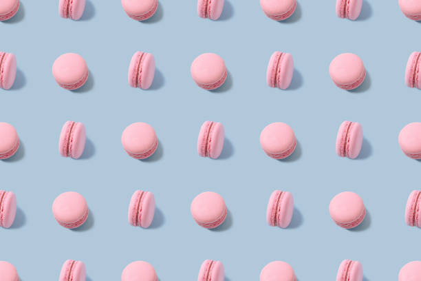 Sweet colorful macarons isolated on blue stock photo