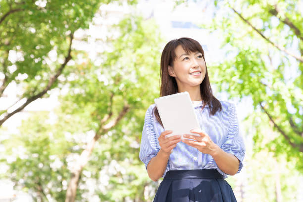 istock asian woman to see a tablet computer 1201325086