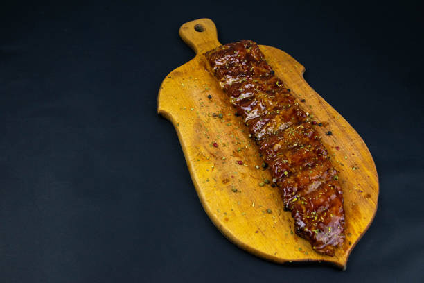 istock Barbecue Pork Spare Ribs as top view on an old cutting board 1201327206