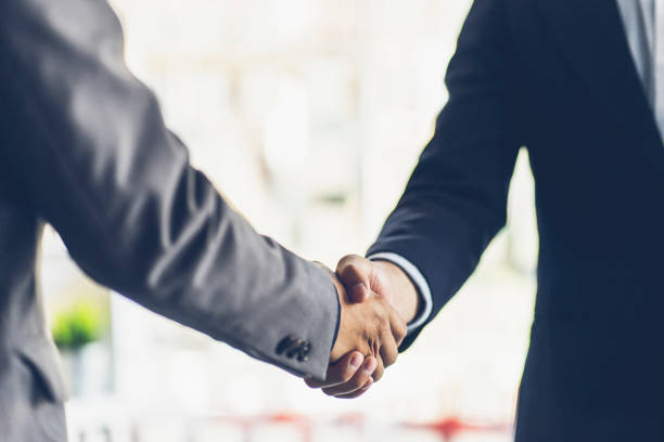 Business people shaking hands at the office. Success teamwork, partnership and handshake business concept stock photo