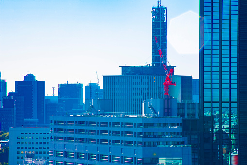 Moving cranes at top of the building long shot. Bunkyo district Suidobashi Tokyo Japan - 11.11.2019