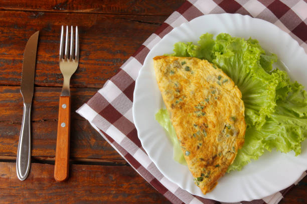 istock simple homemade egg omelet on plate on rustic wooden table. 1201333329