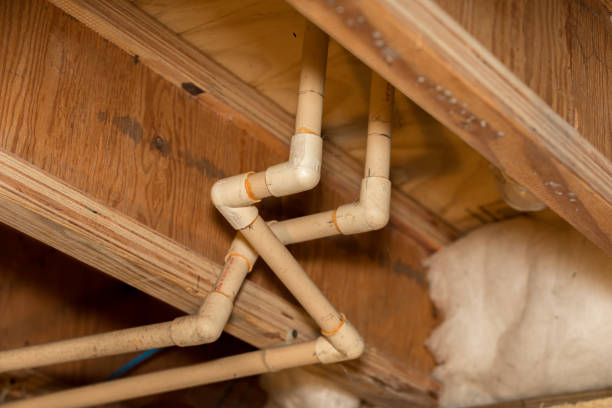 istock Old PVC plastic water supply pipes installed under house in crawlspace. Hot and cold water plumbing system for bathroom sink and shower 1201336076