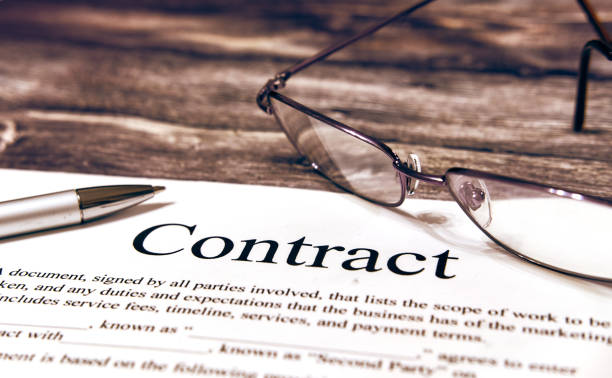 financial contrak and pen. points lie next to each other - contract signing document legal system imagens e fotografias de stock
