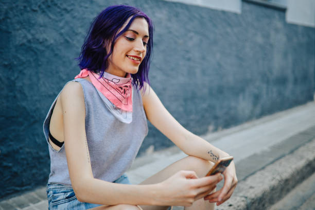 istock Hip girl using phone in the street 1201337362