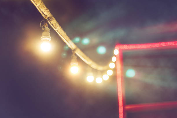 istock blurred bokeh festival night light of city. abstract colourful evening string light bulb background. 1201342500